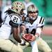 Western Michigan junior Alex Carder hands the ball off to sophomore Antoin Scriven during the second half against Western Michigan at Rynearson Stadium on Saturday afternoon. Melanie Maxwell I AnnArbor.com